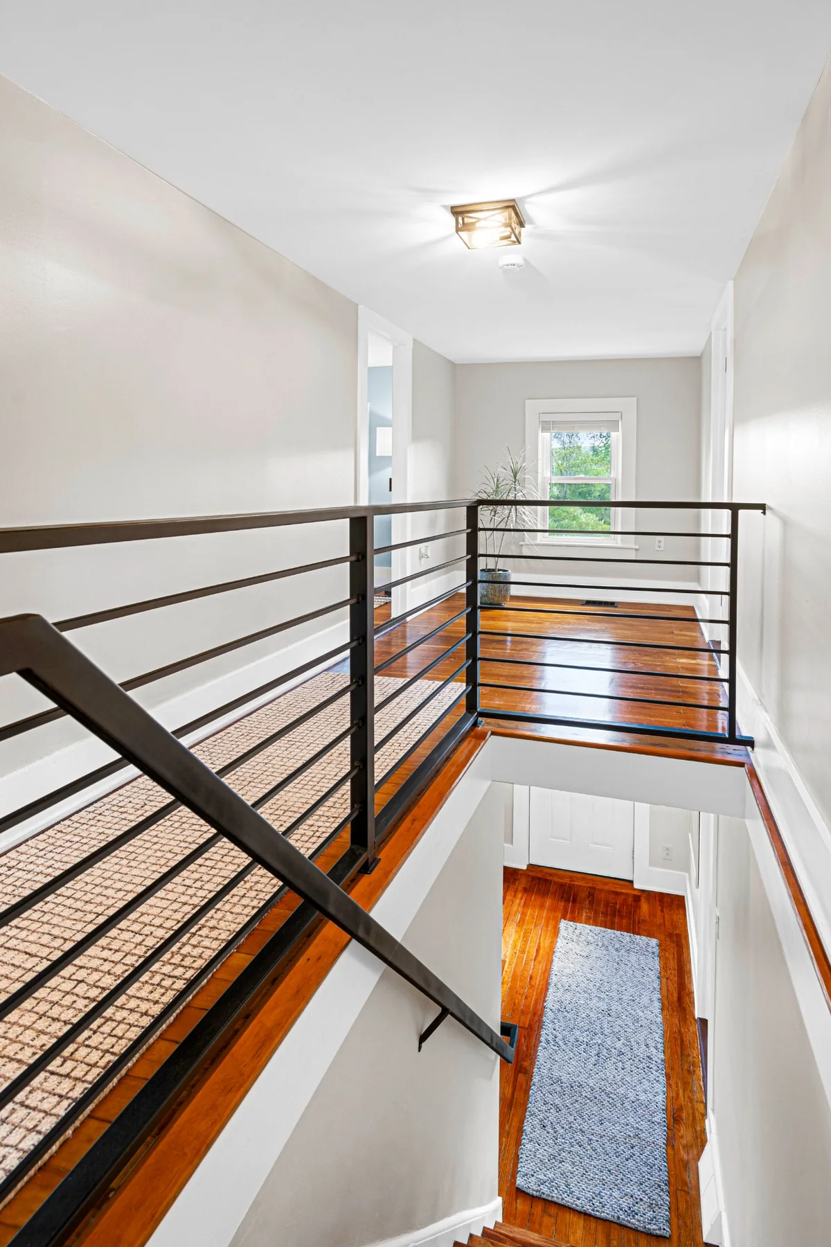 Custom metal railing and refinished hardwood after